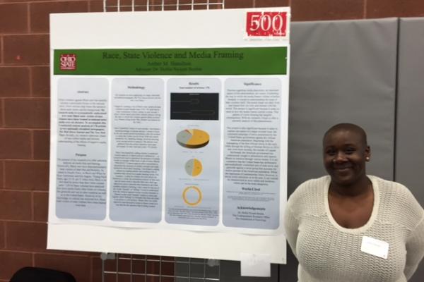 Photo of Ms. Hamilton with her research presentation